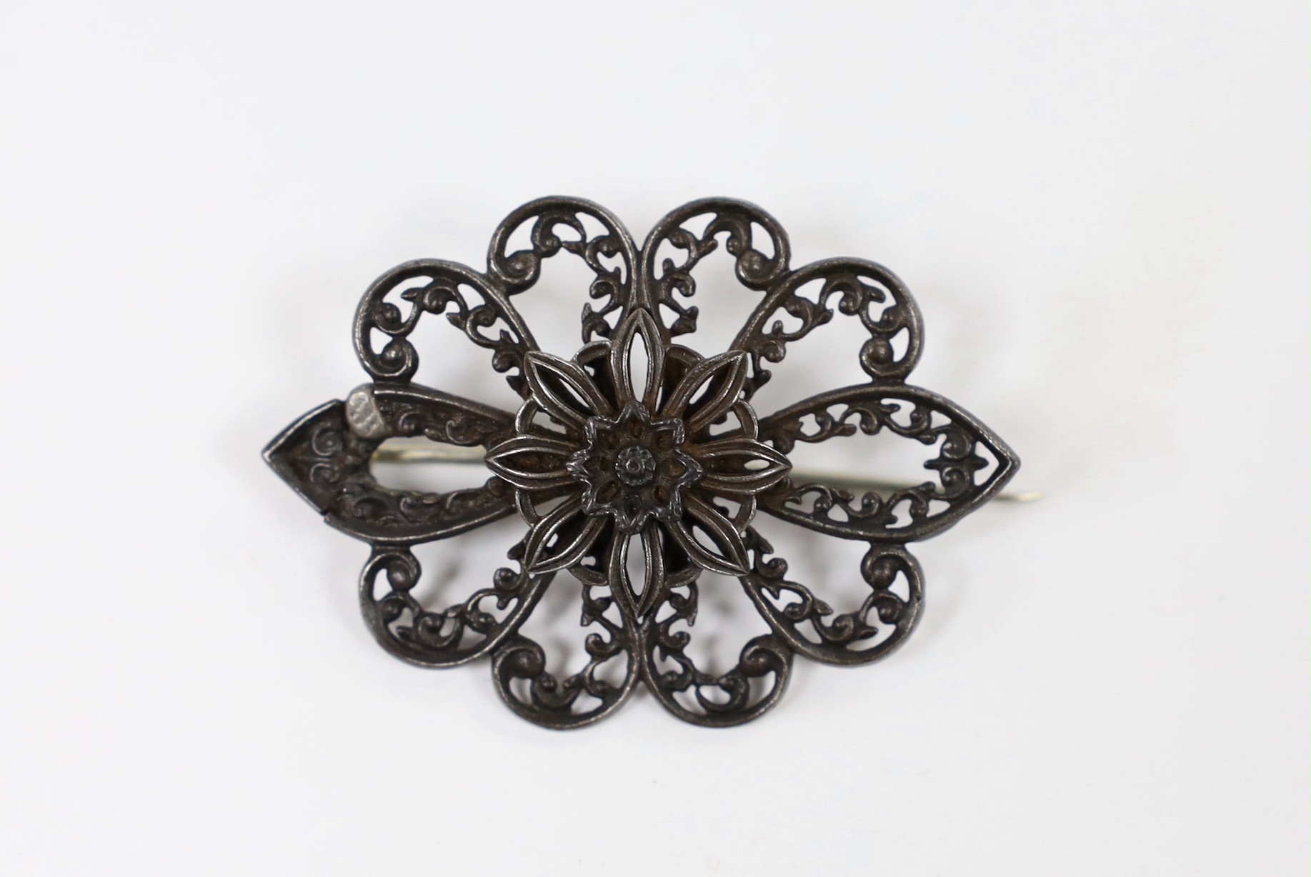 A 19th century Berlin iron work brooch, of shaped oval flower head form (repair), 49mm.
